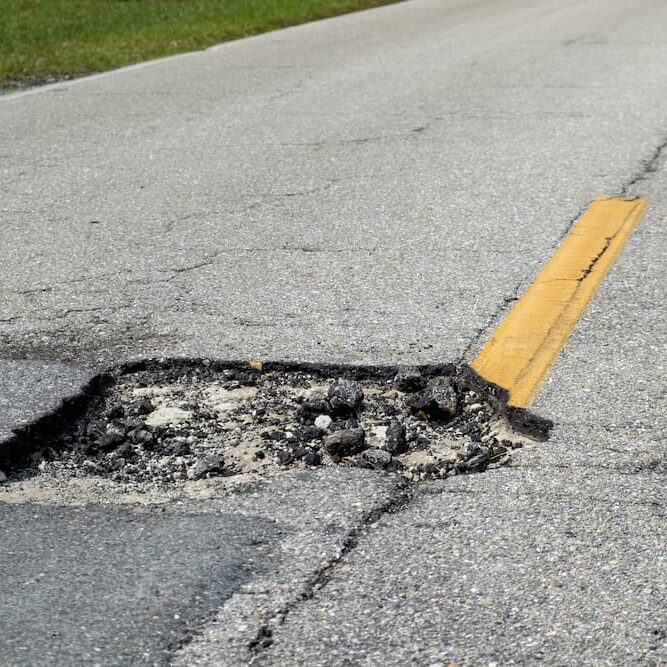 Large pothole on asphalt road